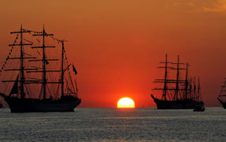 Tall ships at sunset